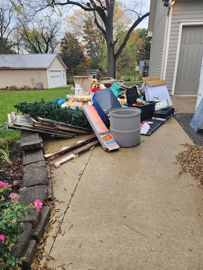 Dumpster being loaded with debris for Roofing Dumpster Rental in North Muskegon